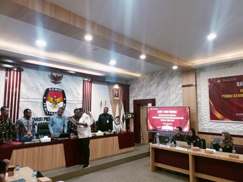 Ketua KPU Fakfak Hendra J.C Talla menyerahkan salinan Keputusan KPU Nomor 3 Tahun 2026 tentang Penetapan Rekapitulasi Data Pemilih Berkelanjutan Kabupaten Fakfak kepada salah satu unsur pimpinan Bawaslu Kabupaten Fakfak.